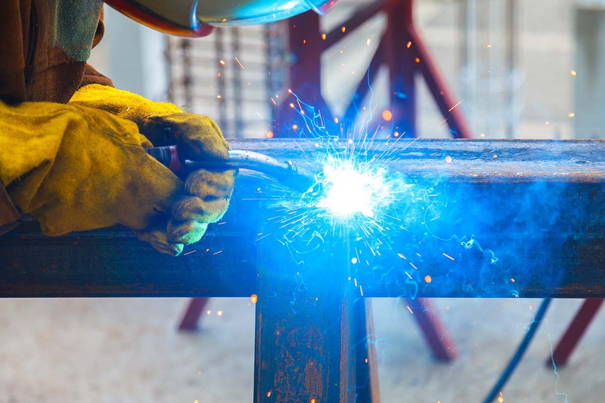 Worker welding in a factory. Welding on an industrial plant.